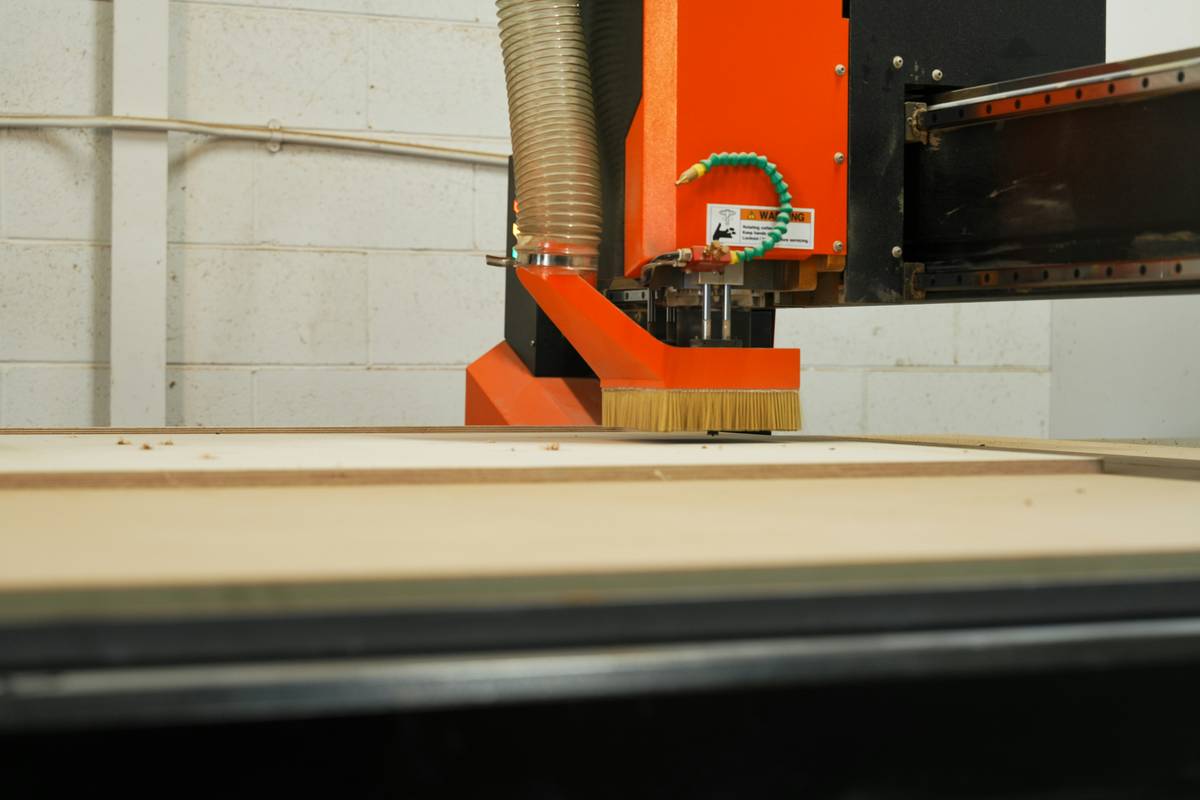 Side-by-side comparison of clean routed edge vs. tear-out caused by wrong bit speed and feed direction